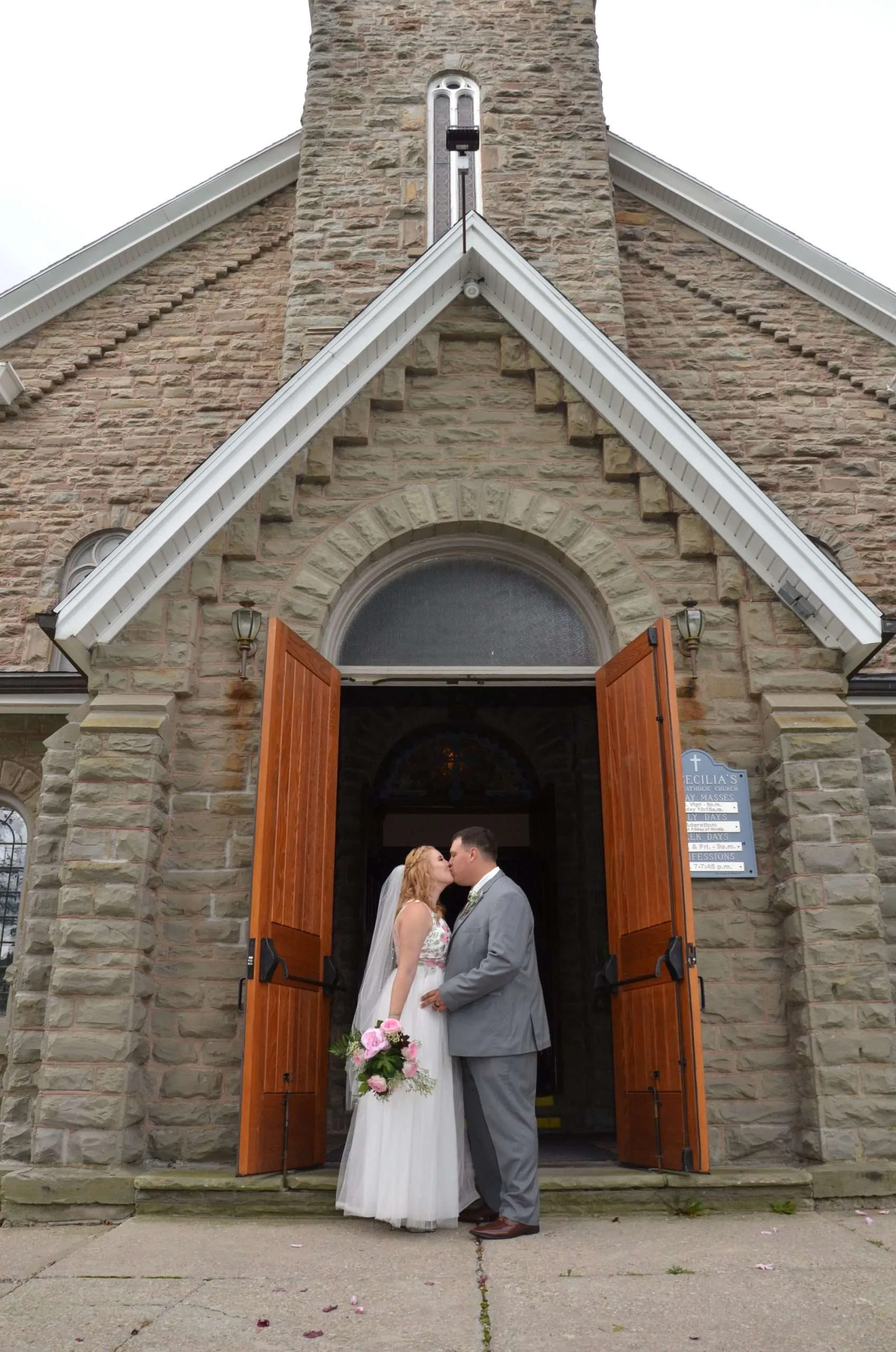 Couple in the doorway of a stone church