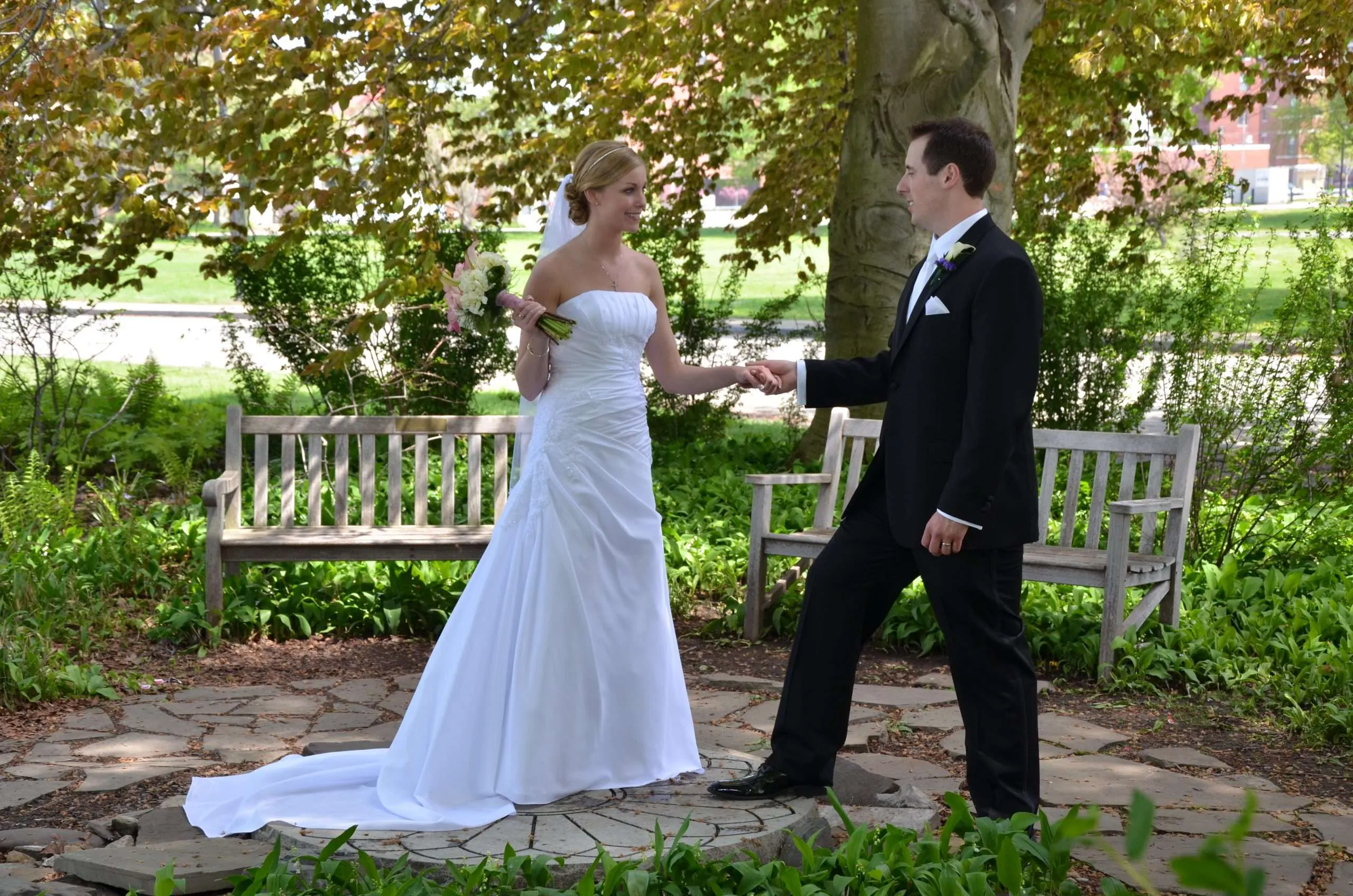 Couple holding hands in a garden